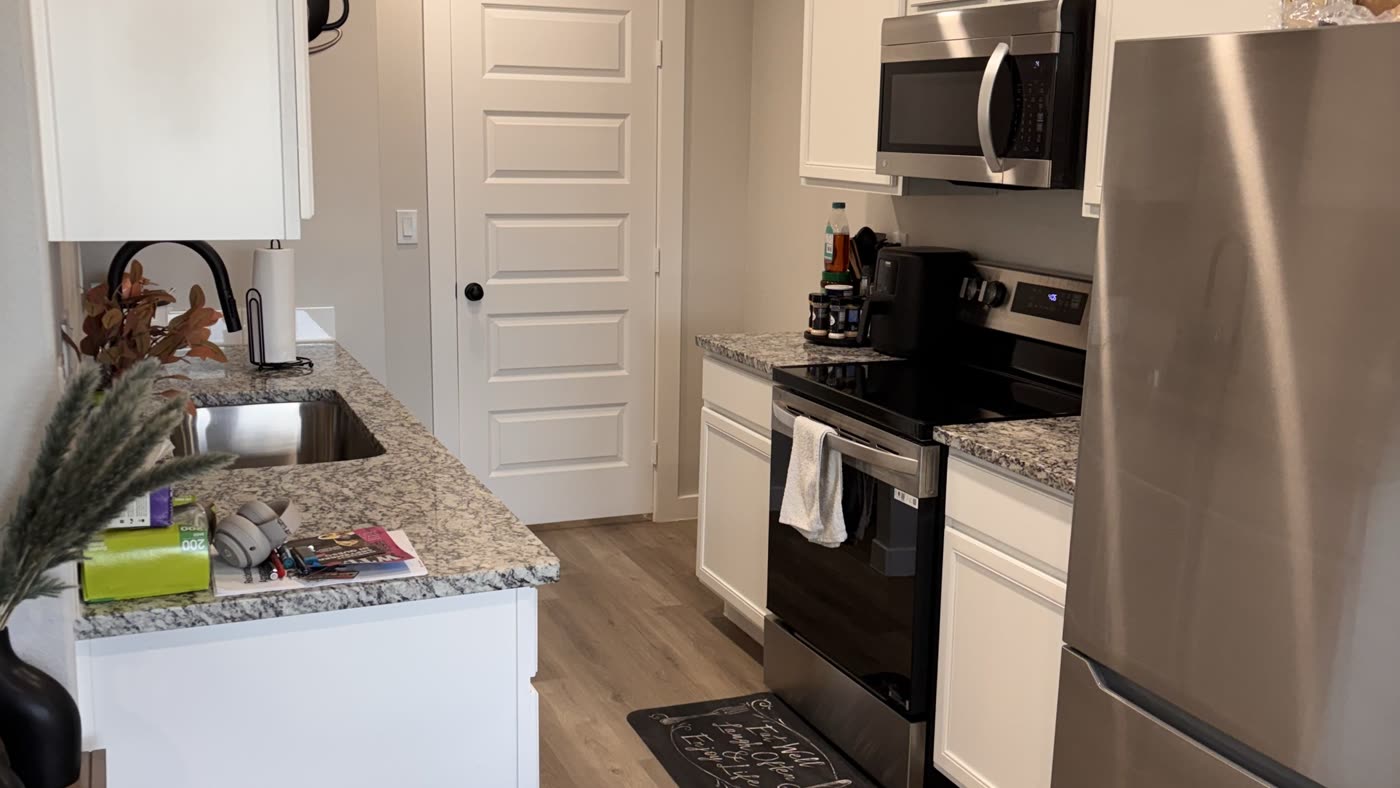 Modern kitchen with stainless appliances, spotless counters