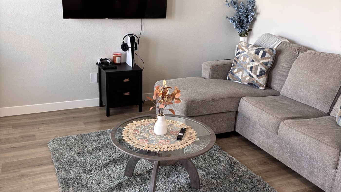 Living room with sectional sofa and rug, cleaned and styled